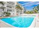 Inviting community pool with surrounding lounge chairs at 19610 Gulf Blvd # 308, Indian Shores, FL 33785