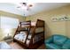 Bedroom with a bunk bed, ceiling fan, and armchair at 19610 Gulf Blvd # 308, Indian Shores, FL 33785