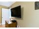 Bedroom with mounted TV and dresser at 19610 Gulf Blvd # 308, Indian Shores, FL 33785