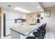 White kitchen with granite island and breakfast bar at 19610 Gulf Blvd # 308, Indian Shores, FL 33785