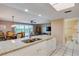 Kitchen with granite island, opens to dining and living area at 19610 Gulf Blvd # 308, Indian Shores, FL 33785