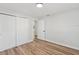 Bright bedroom with wood-look floors and double door closet at 5425 Waters Edge Dr, New Port Richey, FL 34653