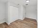 Spacious bedroom with wood-look floors and double door closet at 5425 Waters Edge Dr, New Port Richey, FL 34653