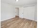 Spacious bedroom featuring wood-look floors and ample closet space at 5425 Waters Edge Dr, New Port Richey, FL 34653