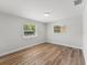 Well-lit bedroom with wood-look floors and window views at 5425 Waters Edge Dr, New Port Richey, FL 34653