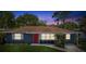 Cute house with red door, blue exterior, and a nicely landscaped yard at 5425 Waters Edge Dr, New Port Richey, FL 34653