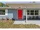 Inviting front entrance features a red door and updated siding at 5425 Waters Edge Dr, New Port Richey, FL 34653