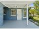 Covered front porch with white door and blue exterior at 5425 Waters Edge Dr, New Port Richey, FL 34653
