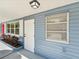 Updated house exterior boasts a fresh blue color, red door, and landscaping at 5425 Waters Edge Dr, New Port Richey, FL 34653