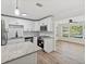 Modern kitchen with white cabinets, granite countertops, and stainless steel appliances at 5425 Waters Edge Dr, New Port Richey, FL 34653