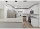 Modern kitchen with white cabinets, granite countertops, and stainless steel appliances at 5425 Waters Edge Dr, New Port Richey, FL 34653