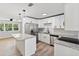 Modern kitchen with white cabinets, granite countertops, and stainless steel appliances at 5425 Waters Edge Dr, New Port Richey, FL 34653