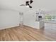 Light and bright living room with new flooring and ceiling fan at 5425 Waters Edge Dr, New Port Richey, FL 34653