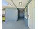 Covered side porch with exterior storage and blue siding at 5425 Waters Edge Dr, New Port Richey, FL 34653