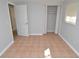 Simple bedroom with tile floors, neutral walls and a closet at 8214 Alafia Ridge Rd, Riverview, FL 33569