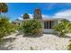 House exterior with stone chimney and landscaping at 850 Mandalay Ave, Clearwater Beach, FL 33767