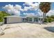 House exterior with garage and tropical landscaping at 850 Mandalay Ave, Clearwater Beach, FL 33767