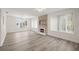 Bright living room with stone fireplace and vinyl plank flooring at 850 Mandalay Ave, Clearwater Beach, FL 33767