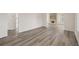 Open living space showcasing hardwood-style floors and views to the fireplace at 850 Mandalay Ave, Clearwater Beach, FL 33767