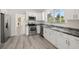 Modern kitchen with white cabinets and granite countertops at 850 Mandalay Ave, Clearwater Beach, FL 33767