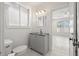 Updated bathroom with gray vanity and textured wall tile at 850 Mandalay Ave, Clearwater Beach, FL 33767
