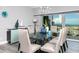 Spacious dining room with glass table, seating for six, and ocean view at 420 64Th Ave # A, St Pete Beach, FL 33706