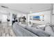 Spacious living room with gray sectional sofa and large TV at 420 64Th Ave # A, St Pete Beach, FL 33706