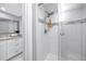 Clean shower with glass enclosure and marble tile at 420 64Th Ave # A, St Pete Beach, FL 33706