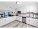Modern kitchen with white cabinets and stainless steel appliances at 420 64Th Ave # A, St Pete Beach, FL 33706