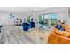 Living room with blue chairs, orange couch, and ocean view at 420 64Th Ave # A, St Pete Beach, FL 33706