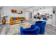 Open living room and kitchen with blue and orange furniture at 420 64Th Ave # A, St Pete Beach, FL 33706