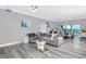 Bright and airy living room with gray sectional sofa and glass coffee table at 420 64Th Ave # A, St Pete Beach, FL 33706
