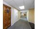 Building hallway with wood door and carpeted floor at 420 64Th Ave # A, St Pete Beach, FL 33706