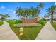 Attractive entrance to Bellair Country Club with landscaping and signage at 6 Hibiscus Ln, Belleair, FL 33756