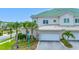 Home exterior with green roof, landscaping, and driveway at 6 Hibiscus Ln, Belleair, FL 33756