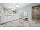 Bathroom with double vanity, large shower, and bench at 6 Hibiscus Ln, Belleair, FL 33756