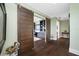 Elegant hallway with dark hardwood floors and barn doors at 6 Hibiscus Ln, Belleair, FL 33756