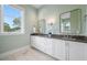 Spa-like bathroom with double vanity and large window at 6 Hibiscus Ln, Belleair, FL 33756