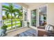 Covered porch with wicker seating and view of neighborhood at 6 Hibiscus Ln, Belleair, FL 33756