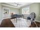 Home office features hardwood floors, desk, and window views at 6 Hibiscus Ln, Belleair, FL 33756