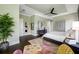 Main bedroom with king bed, hardwood floors, and ceiling fan at 6 Hibiscus Ln, Belleair, FL 33756