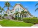 Attractive two-story home with lush landscaping and palm trees at 6 Hibiscus Ln, Belleair, FL 33756