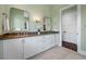 Bathroom with double vanity, granite countertop, and large mirrors at 6 Hibiscus Ln, Belleair, FL 33756