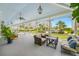 Relaxing community porch with wicker furniture and views of the pool and grounds at 6 Hibiscus Ln, Belleair, FL 33756
