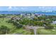 Wide aerial view showing a home near golf course and waterfront at 6 Hibiscus Ln, Belleair, FL 33756