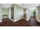Upper hallway with hardwood floors and a large mirror at 6 Hibiscus Ln, Belleair, FL 33756