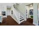 Elegant staircase with white railing and dark hardwood floors at 6 Hibiscus Ln, Belleair, FL 33756