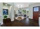 Bright entryway with hardwood floors, seating area, and view to backyard at 6 Hibiscus Ln, Belleair, FL 33756