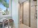 Walk-in shower with tiled walls and a built-in seat at 6 Hibiscus Ln, Belleair, FL 33756