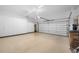 Spacious garage with storage cabinets and epoxy floor at 6 Hibiscus Ln, Belleair, FL 33756